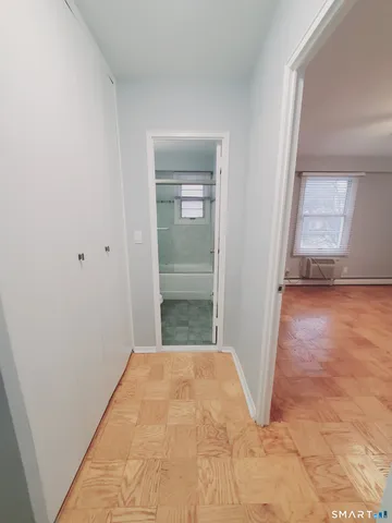 a view of a room with wooden floor and a bathroom