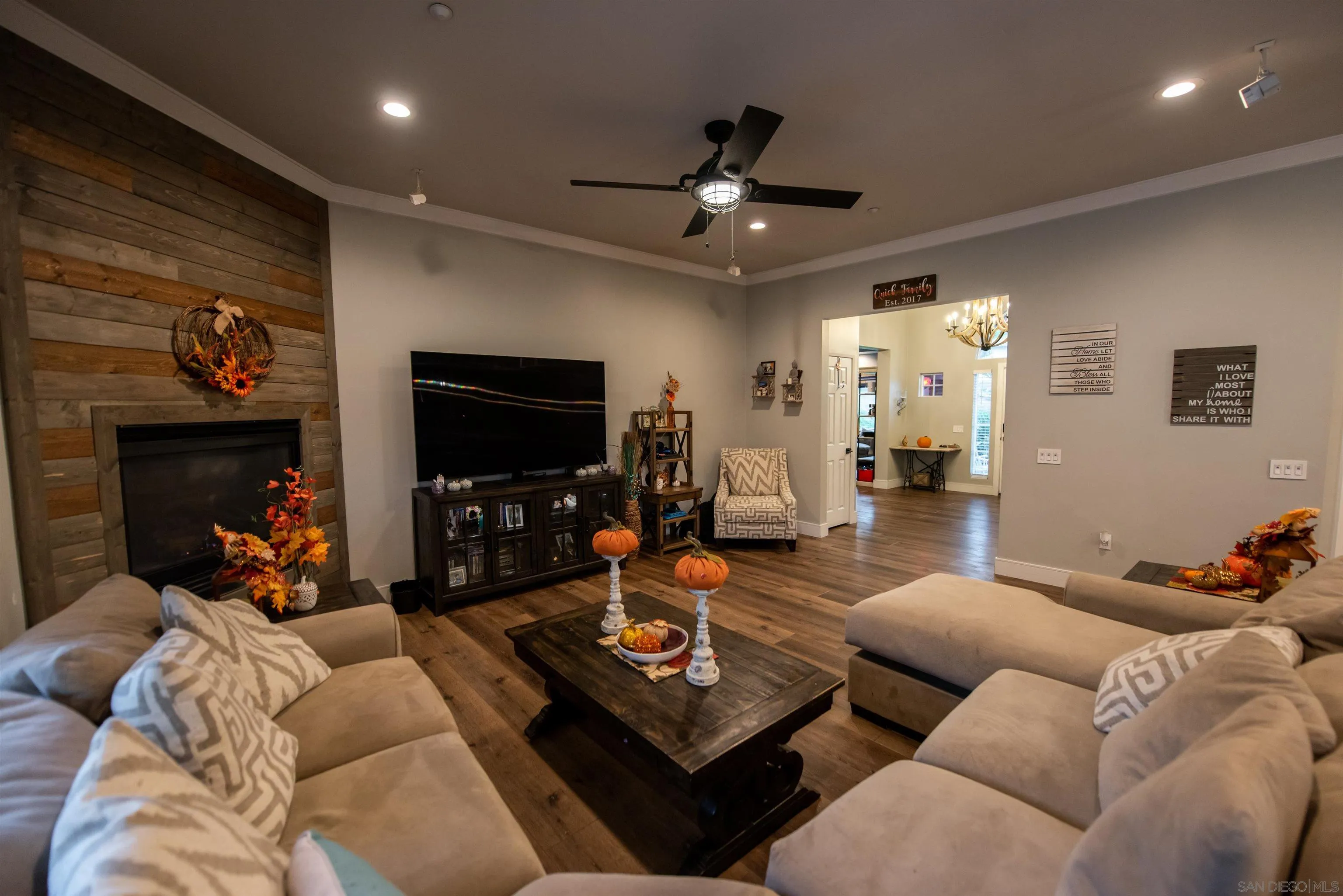 8945 Diamondback Drive Santee, CA 92071 - Photo 15 of 49 a living room with furniture a flat screen tv and a fireplace