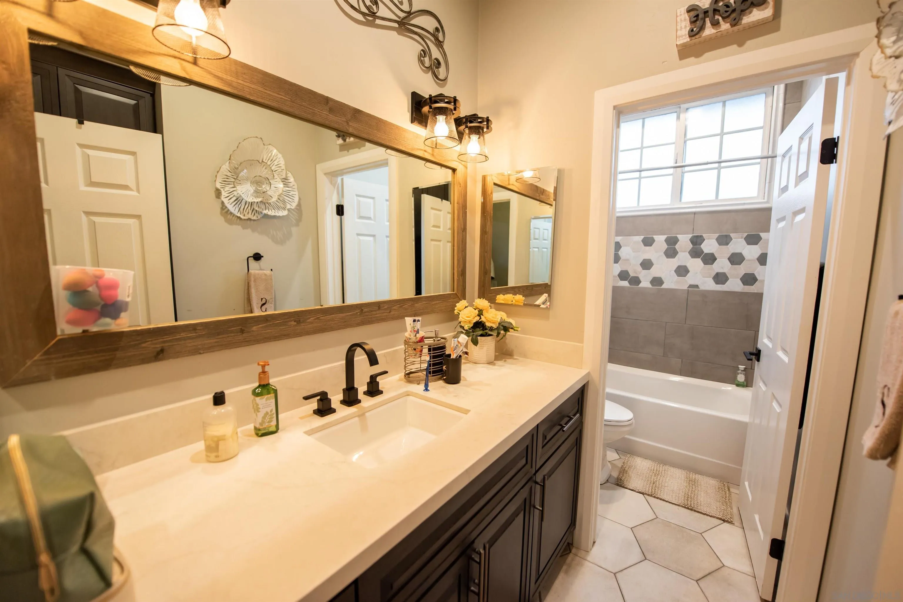 8945 Diamondback Drive Santee, CA 92071 - Photo 25 of 49 a bathroom with a sink a toilet a tub and shower