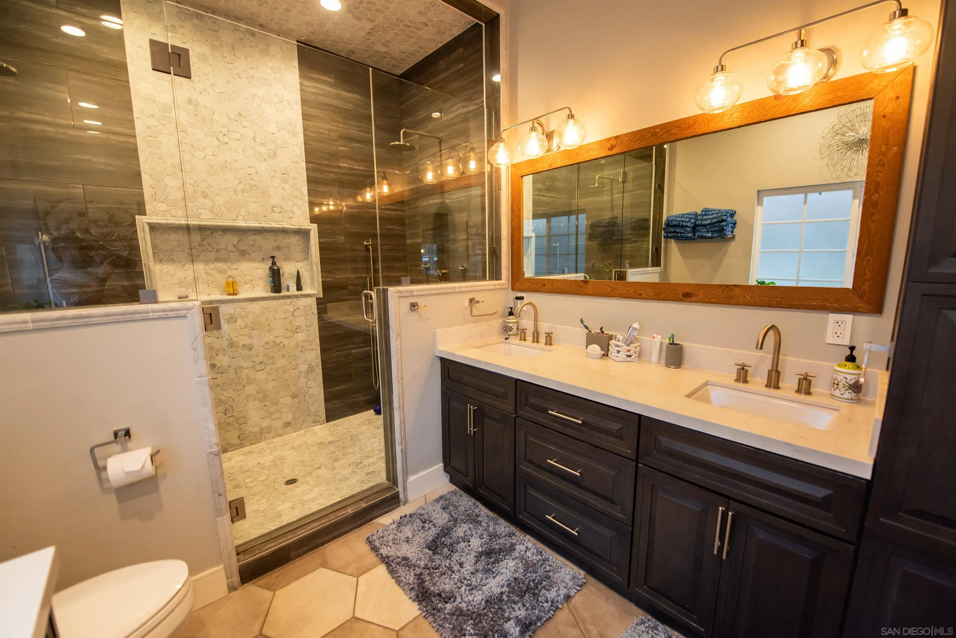 8945 Diamondback Drive Santee, CA 92071 - Photo 26 of 49 a bathroom with a double vanity sink toilet and mirror