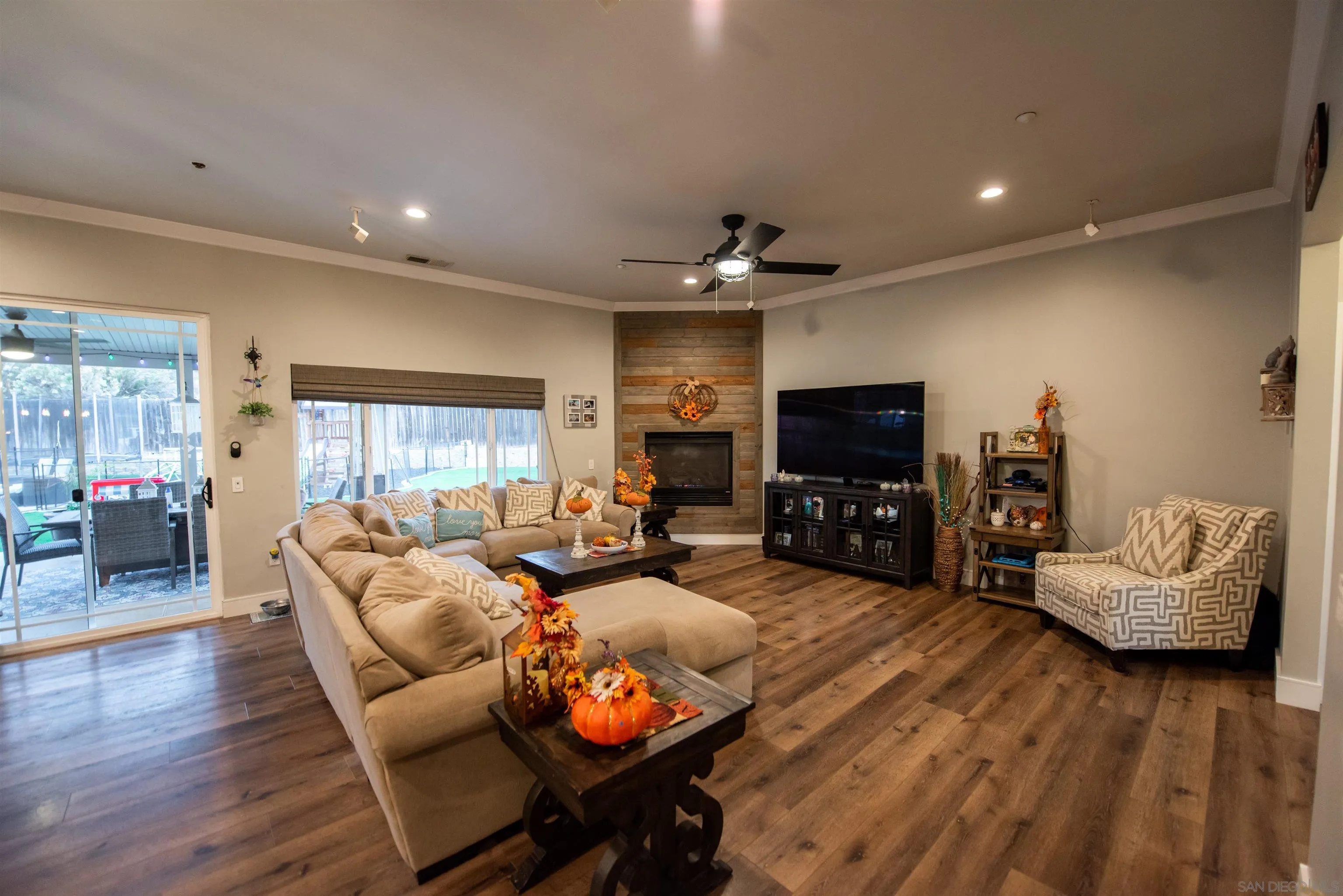 8945 Diamondback Drive Santee, CA 92071 - Photo 37 of 49 a living room with furniture a flat screen tv and a fireplace