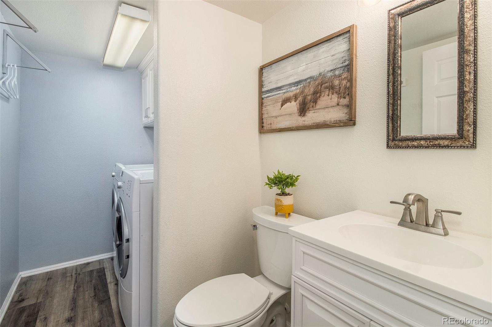 822 Timbervale Trail Highlands Ranch, CO 80129 - Photo 14 of 34 a bathroom with a sink mirror vanity and toilet