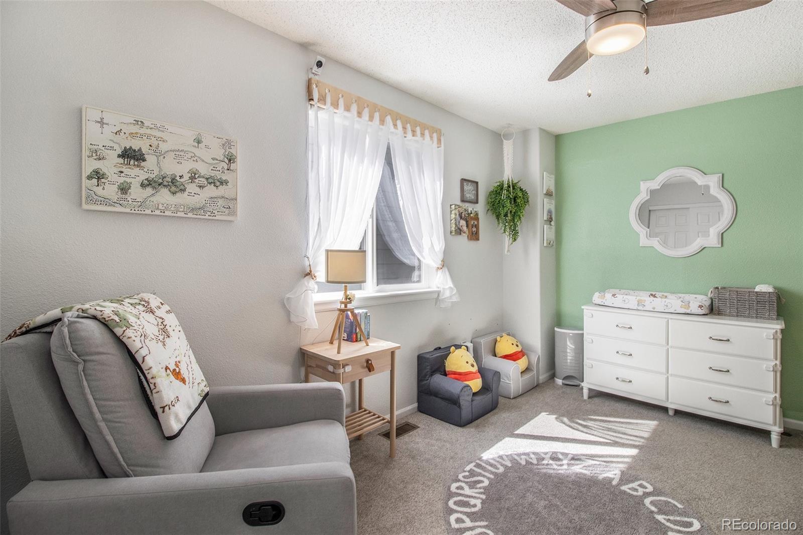 822 Timbervale Trail Highlands Ranch, CO 80129 - Photo 20 of 34 a bedroom with a bed and a window