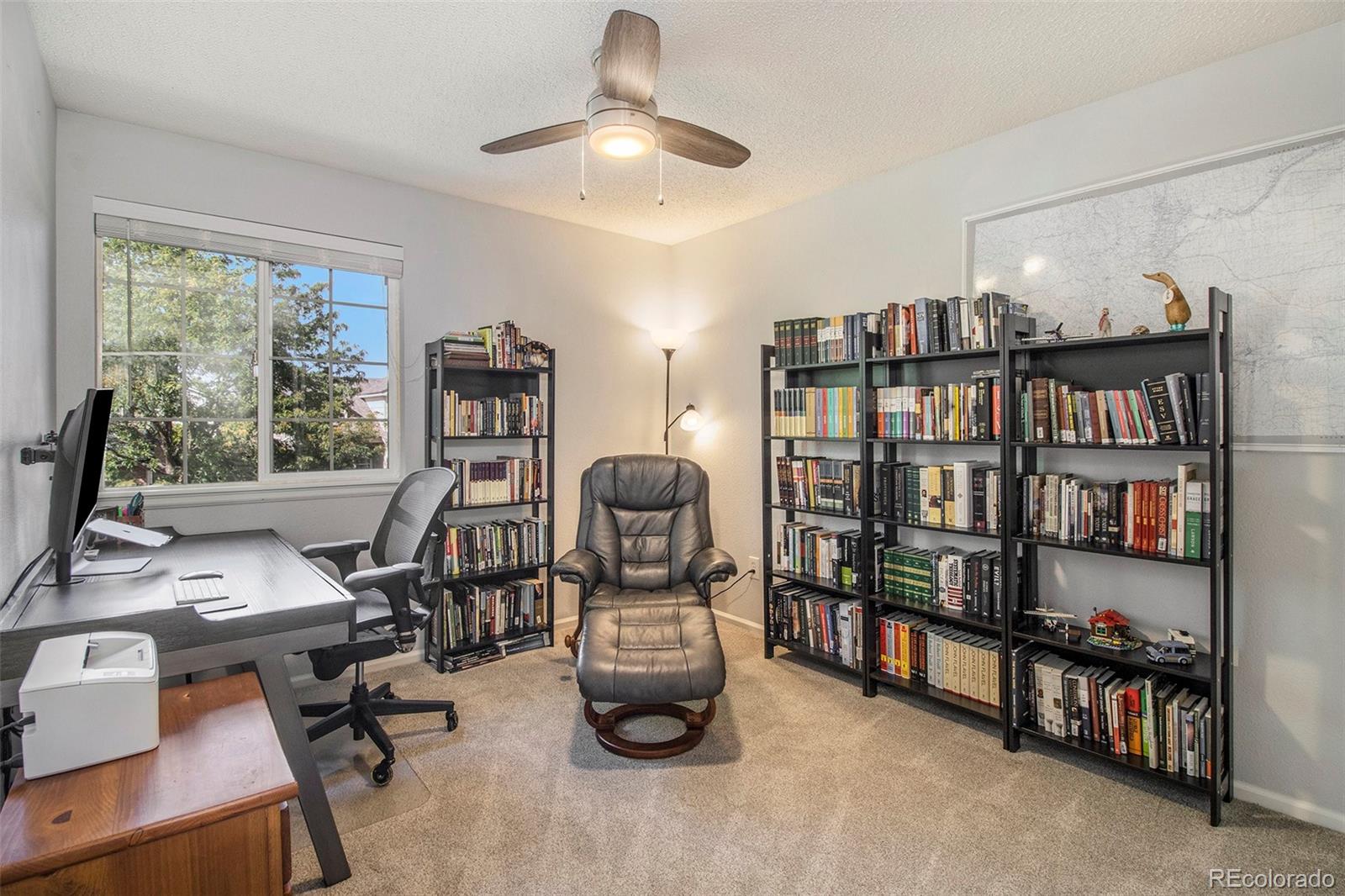 822 Timbervale Trail Highlands Ranch, CO 80129 - Photo 22 of 34 a view of a workspace with furniture and a bookshelf