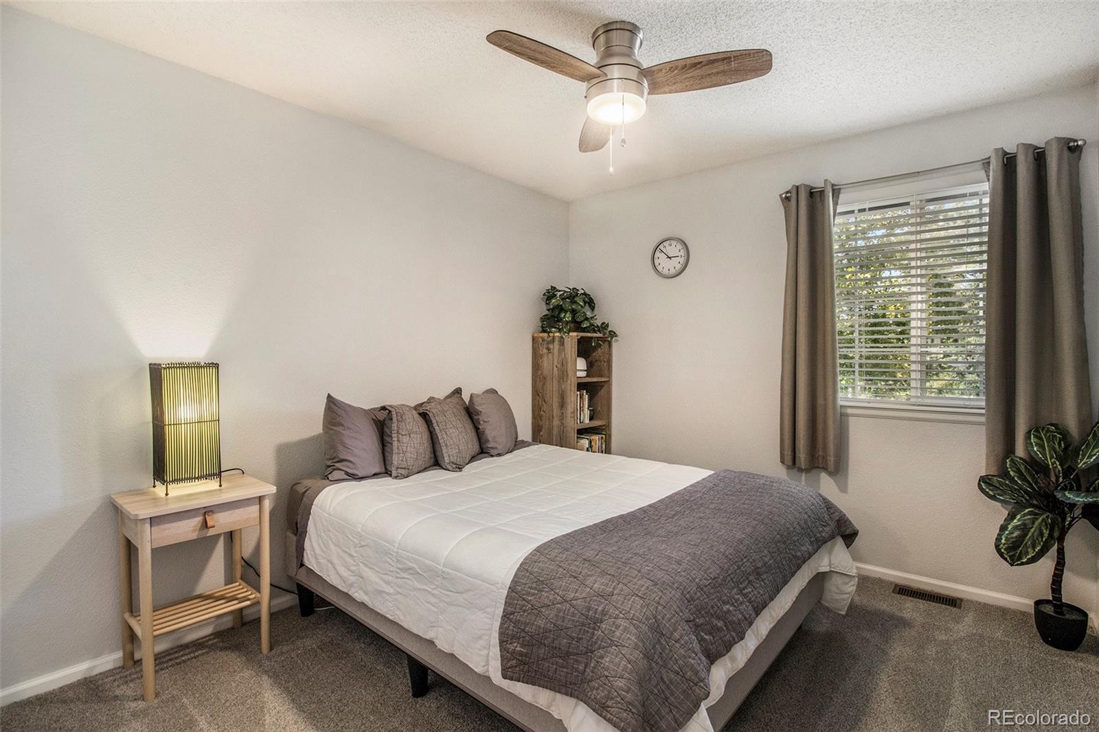 822 Timbervale Trail Highlands Ranch, CO 80129 - Photo 24 of 34 a bedroom with a bed and a table in it with window