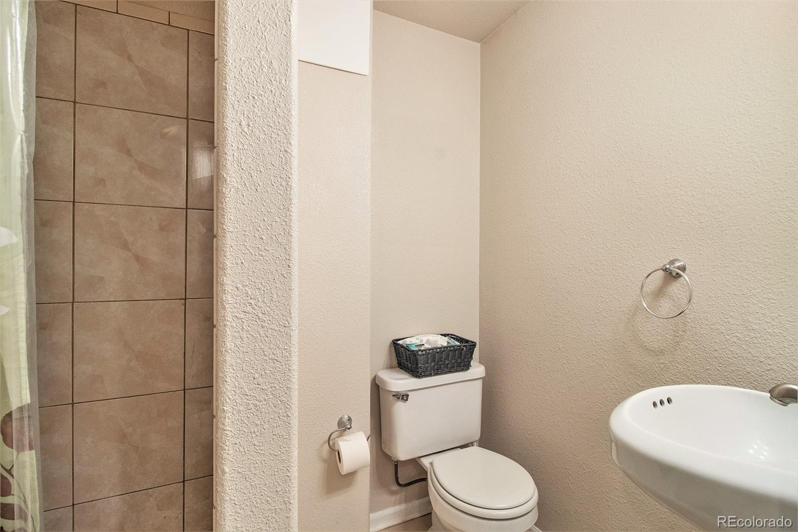 822 Timbervale Trail Highlands Ranch, CO 80129 - Photo 28 of 34 a white toilet sitting next to a bathroom sink