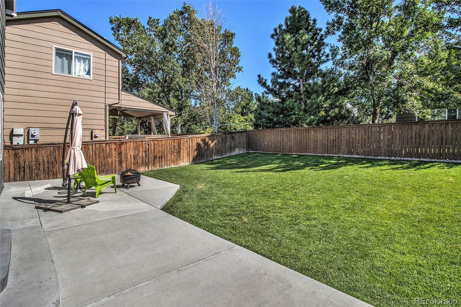 822 Timbervale Trail Highlands Ranch, CO 80129 - Photo 29 of 34 a view of a backyard with a small cabin