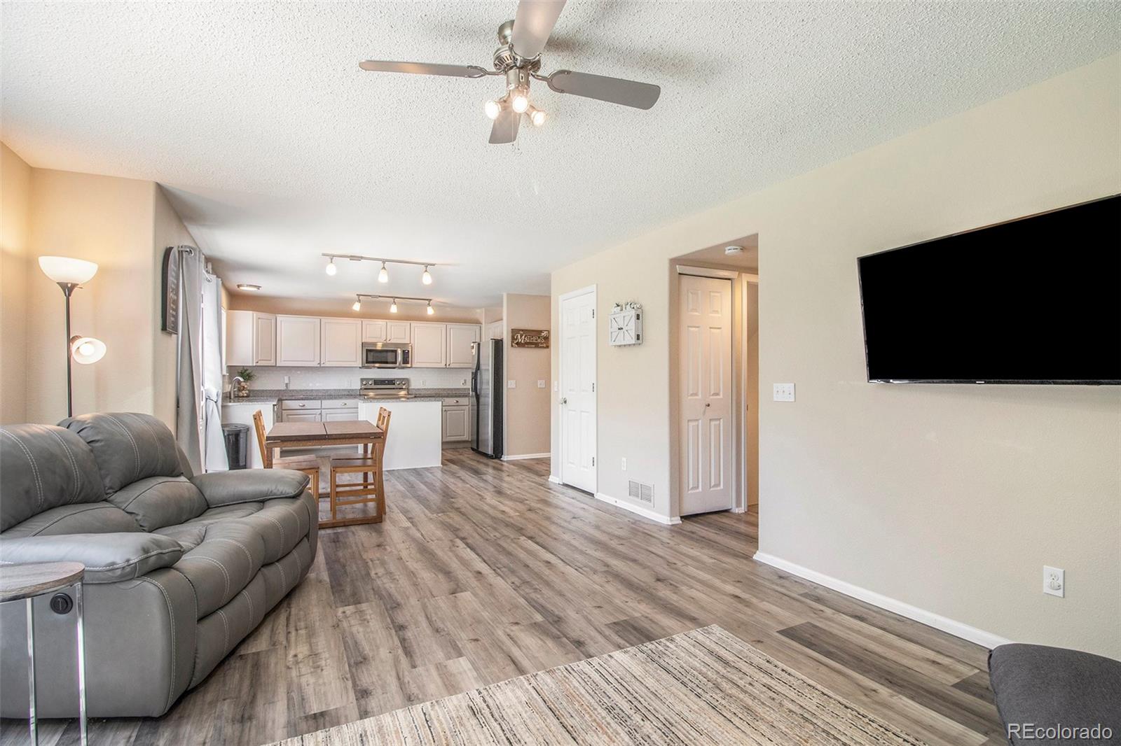 822 Timbervale Trail Highlands Ranch, CO 80129 - Photo 9 of 34 a living room with furniture and a flat screen tv