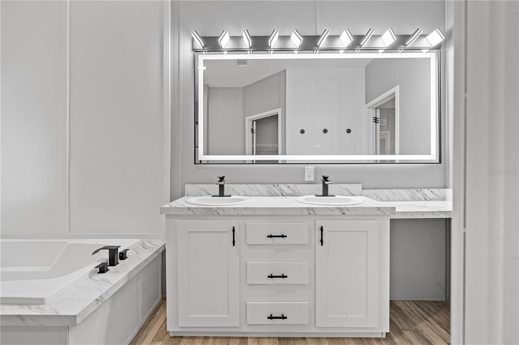 375 Sapp Street Inglis, FL 34449 - Photo 19 of 36 a bathroom with a sink double vanity sink and a bathtub