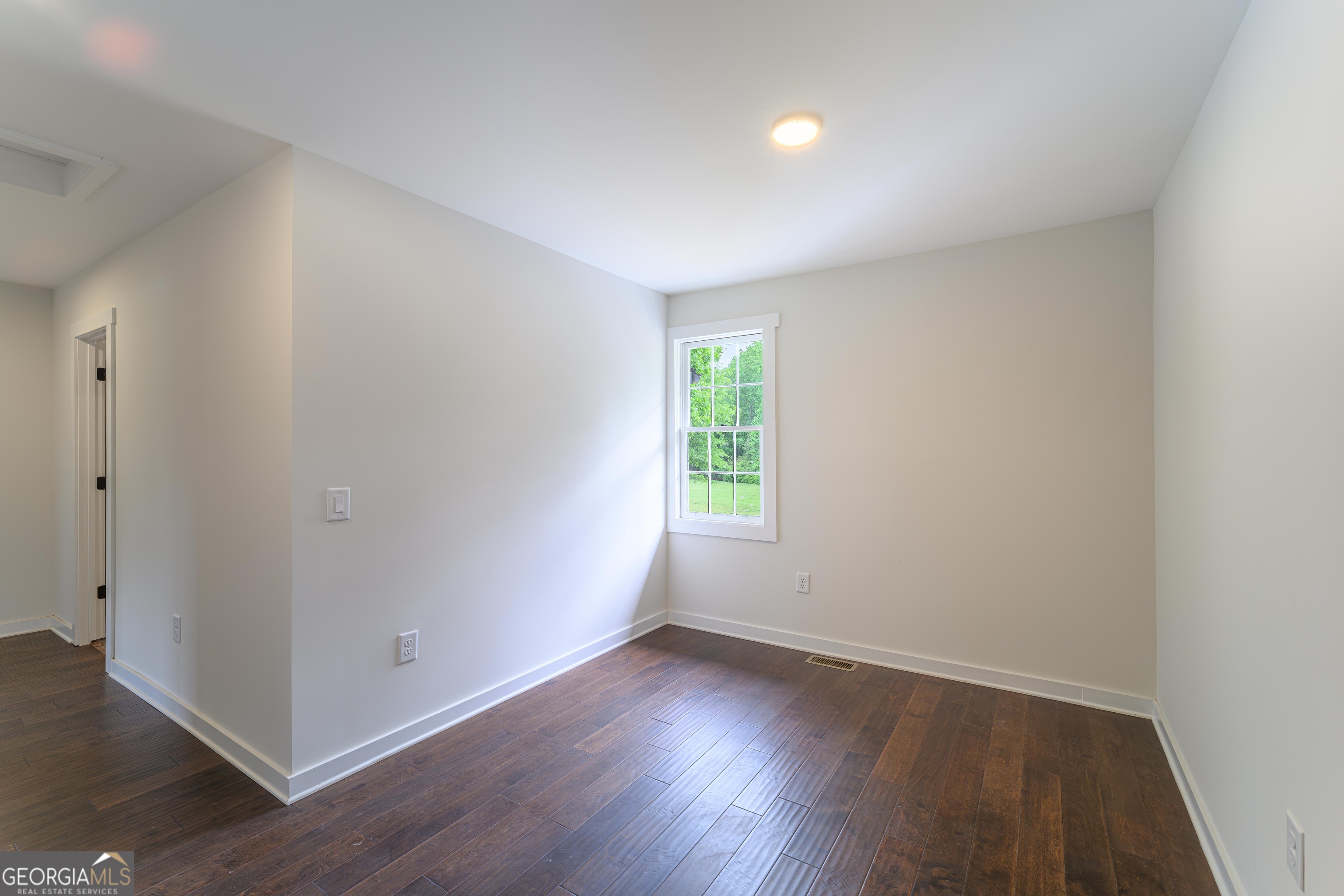 418 Lamb Road Moreland, GA 30259 - Photo 17 of 32 an empty room with wooden floor and windows