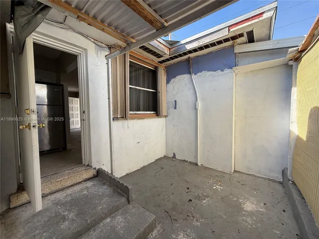 a view of a hallway with wooden shelves