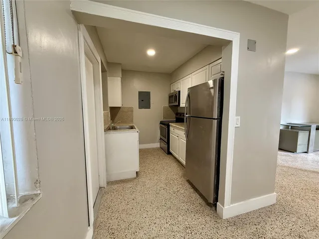 a kitchen with a refrigerator and a sink