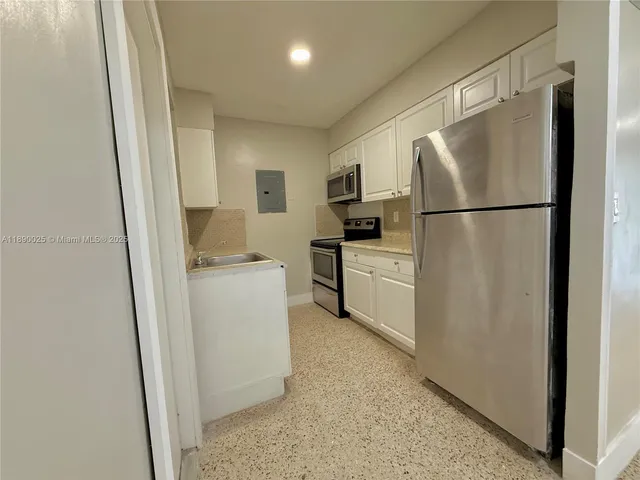 a white refrigerator freezer sitting in a kitchen