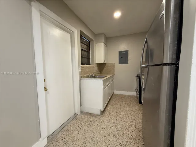 a kitchen with a refrigerator and a sink