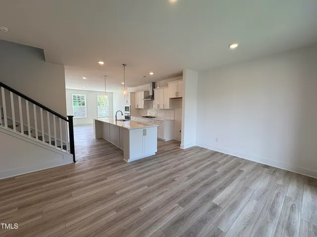 a view of kitchen with wooden floor and window