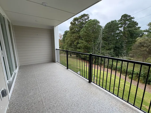 a living room with furniture a flat screen tv and a large window