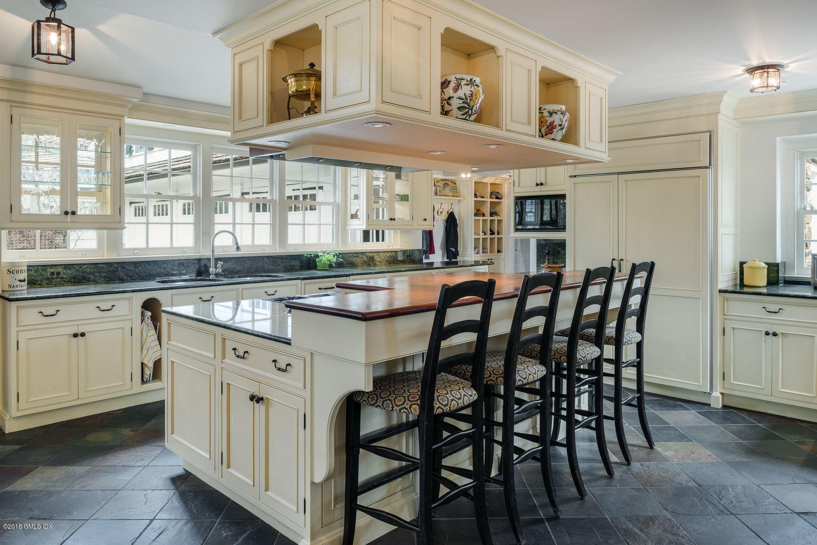 32 Pecksland Road Greenwich, CT 06831 - Photo 9 of 24 a dining hall with stainless steel appliances granite countertop a dining table chairs and a large window