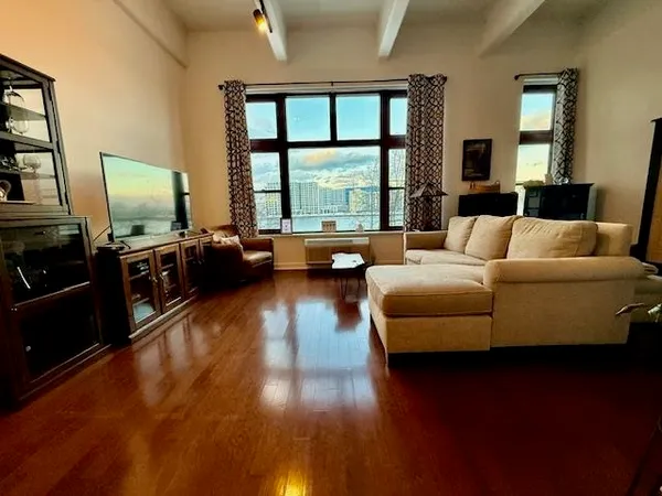 a living room with furniture window and wooden floor