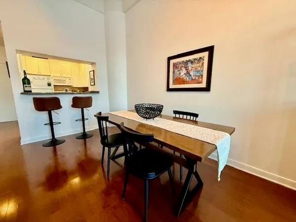a view of a workspace with furniture and wooden floor
