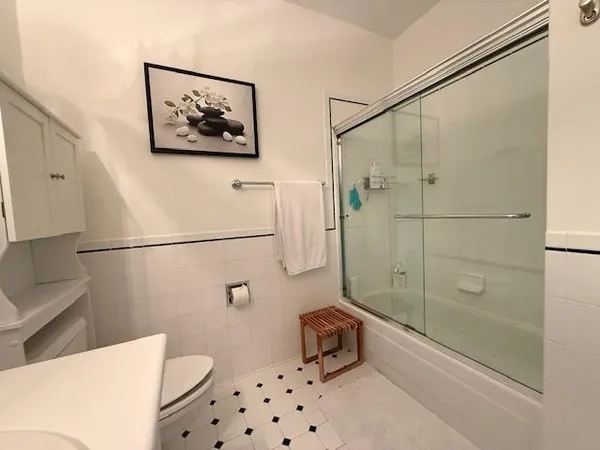 a bathroom with a toilet a sink and shower