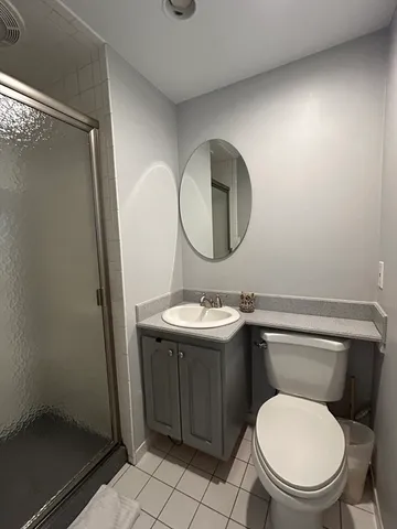 a bathroom with a toilet a sink and mirror