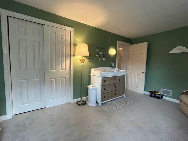 an empty room with a cabinet and mirrors