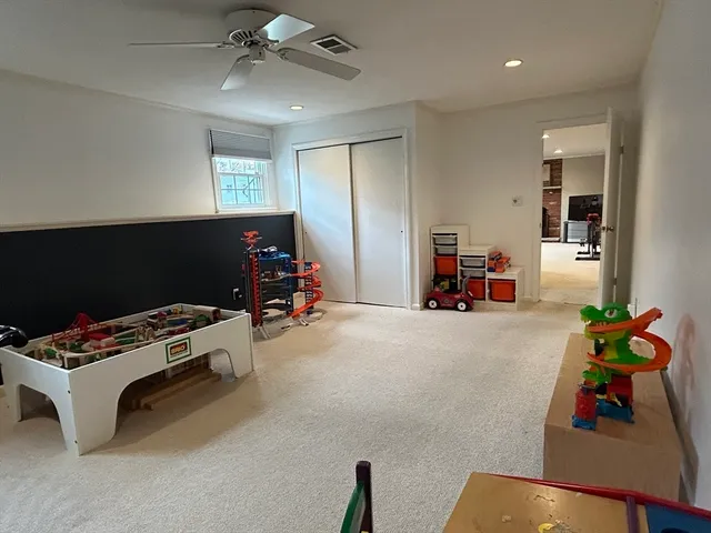 a bedroom with furniture and a fan