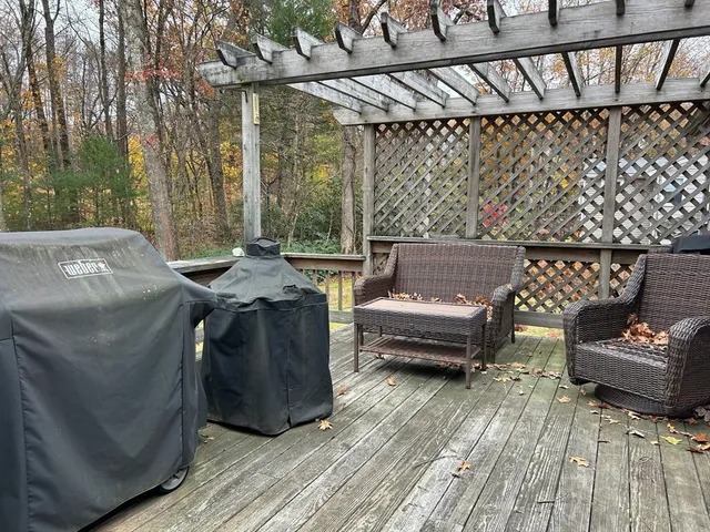 a view of a patio with couches and wooden floor
