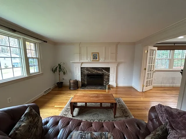 a living room with furniture and a fireplace