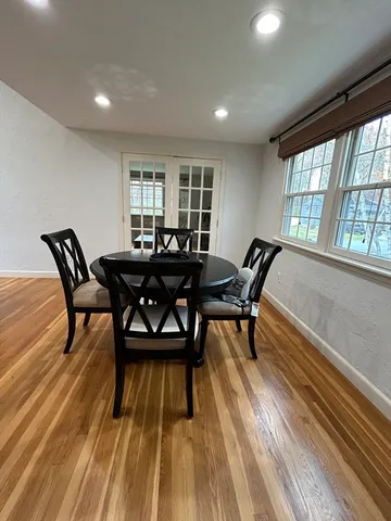 a view of a dining room with furniture and wooden floor