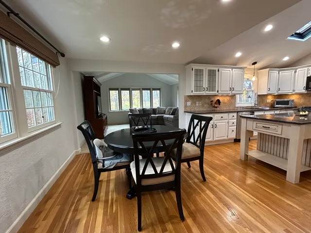 a view of a dining room with furniture and wooden floor