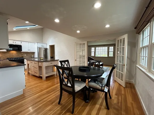 a view of a dining room with furniture and a wooden floor