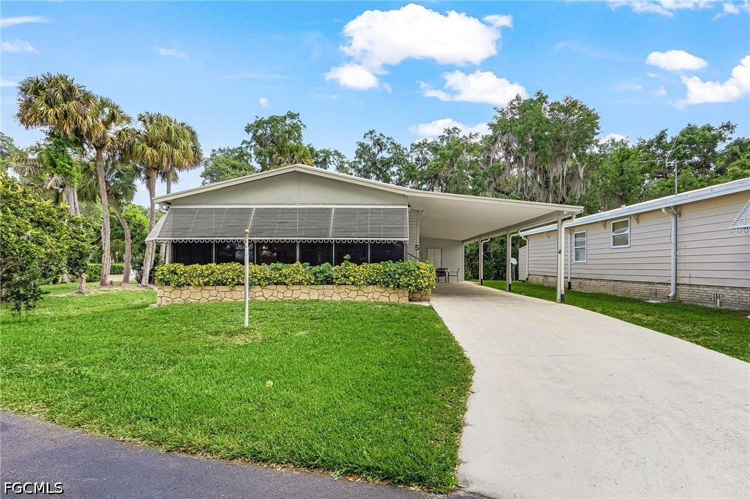 5 Erica Street Alva, FL 33920 - Photo 29 of 37 a front view of a house with garden