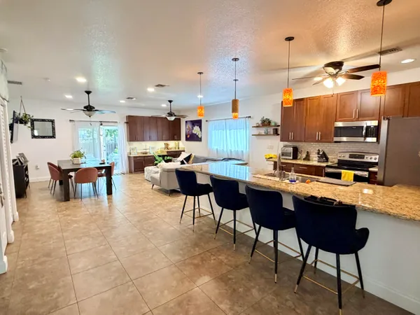 a kitchen with a dining table chairs and a counter top space