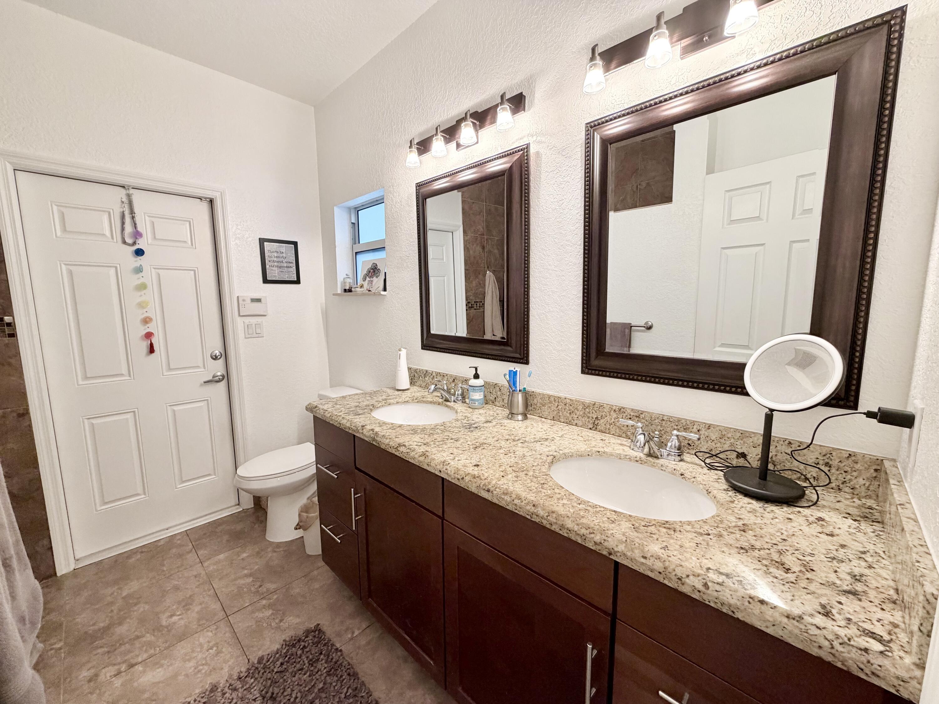243 Southwest 5th Street Dania Beach, FL 33004 - Photo 7 of 18 a bathroom with a granite countertop sink and a mirror