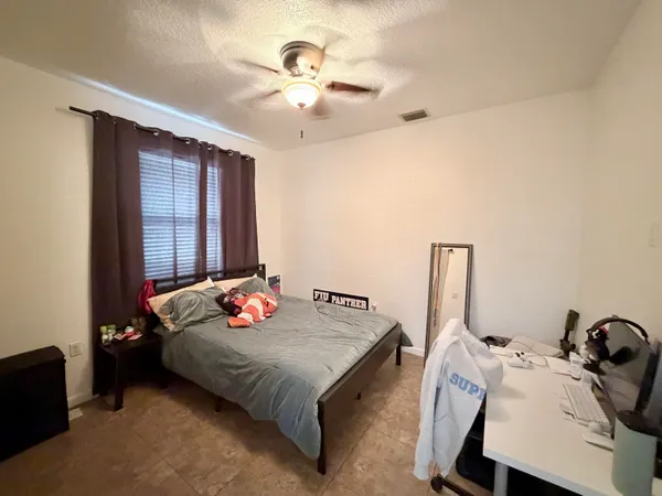 a bedroom with bed and a chandelier