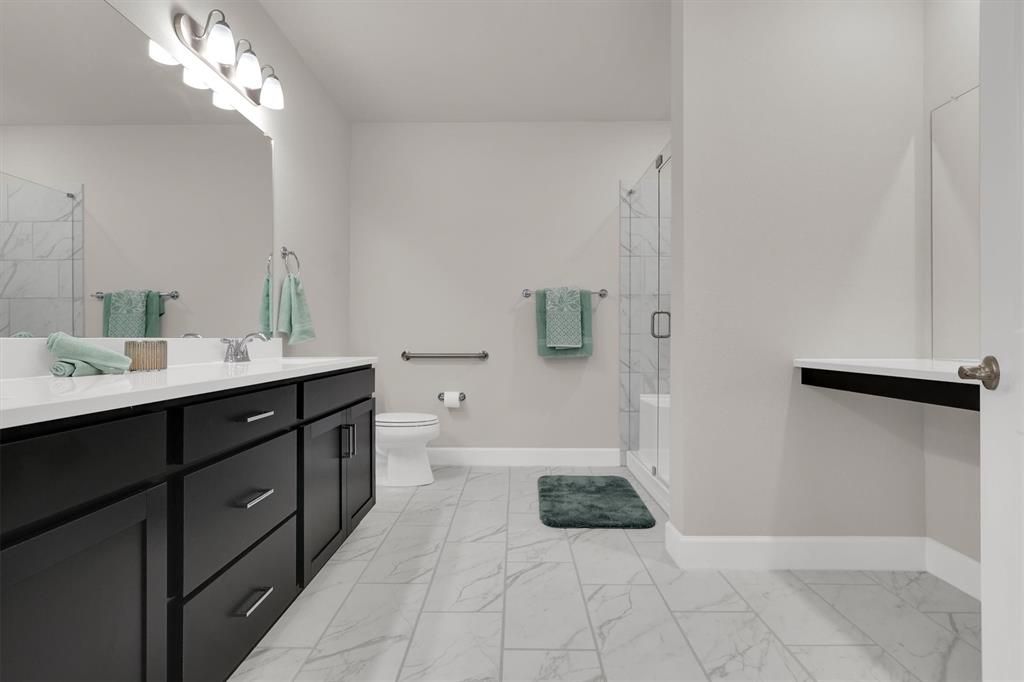 651 Watters Road, Unit 2105 Allen, TX 75013 - Photo 21 of 32 a spacious bathroom with a double vanity sink a toilet a mirror and shower