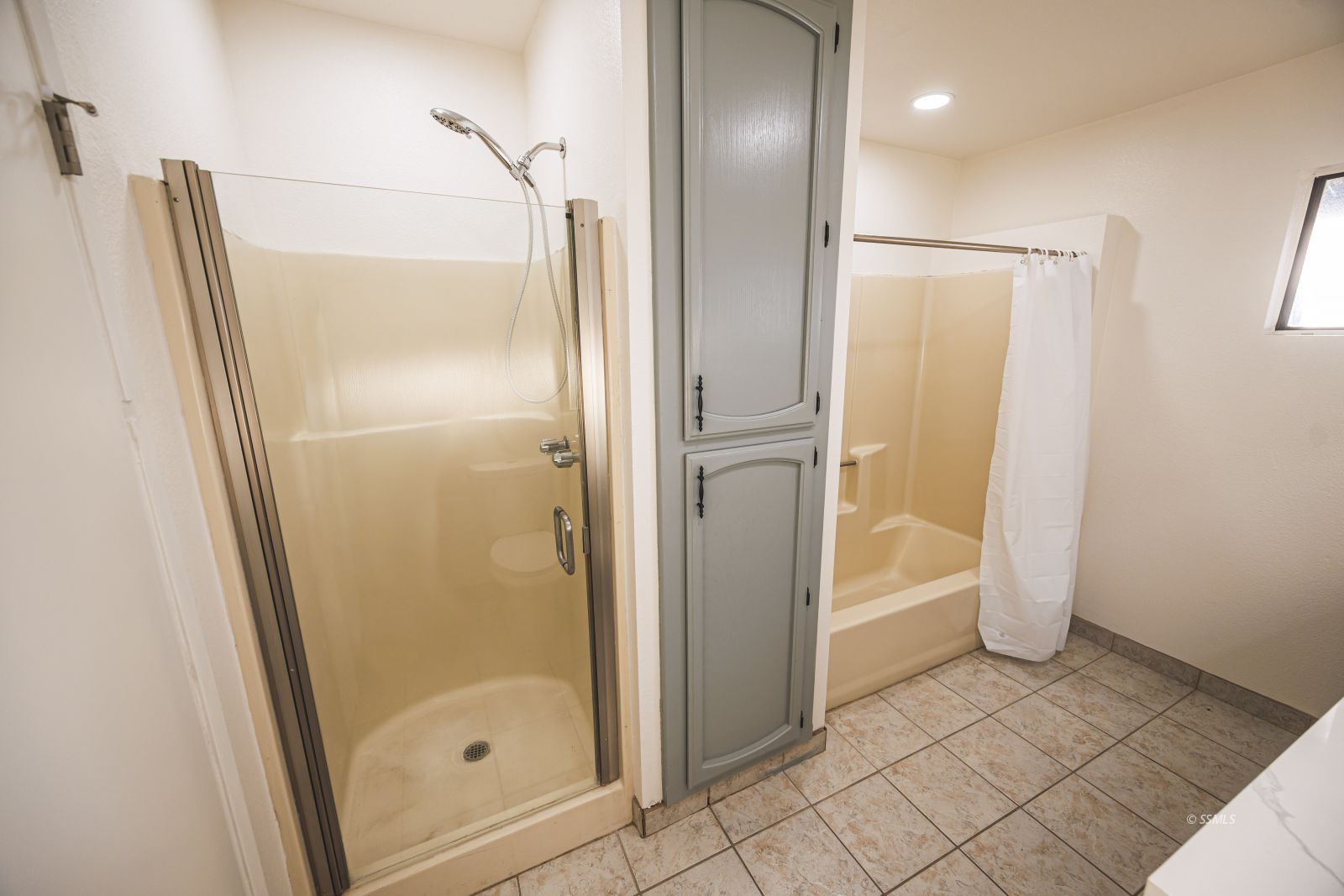 1213 Primrose Street Ridgecrest, CA 93555 - Photo 23 of 37 a bathroom with a glass shower door and a mirror