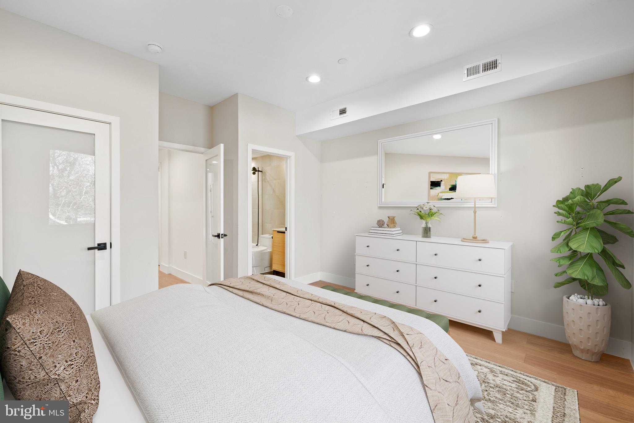 2130 Spring Street Philadelphia, PA 19103 - Photo 19 of 59 a spacious bedroom with a bed and a dresser
