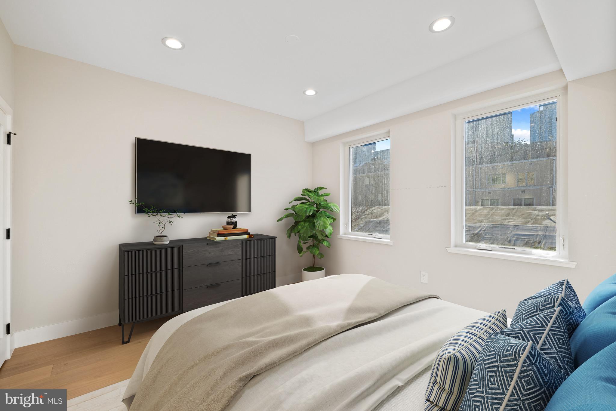 2130 Spring Street Philadelphia, PA 19103 - Photo 23 of 59 a bedroom with a bed and a flat screen tv