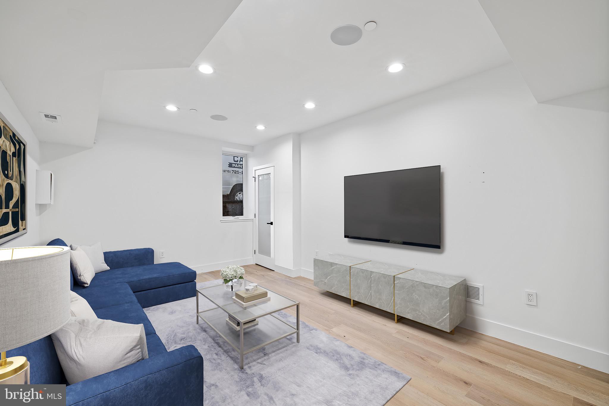 2130 Spring Street Philadelphia, PA 19103 - Photo 41 of 59 a living room with furniture and a flat screen tv