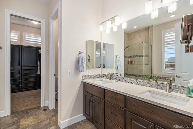 a bathroom with a sink double vanity and a shower