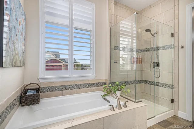 a white bath tub sitting next to a shower