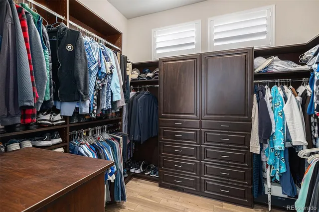 a view of walk in closet with clothes