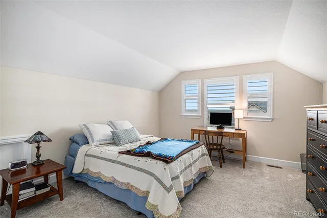 a bedroom with a bed and a desk