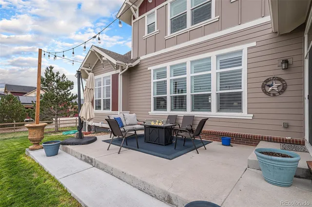 a backyard of a house with outdoor seating