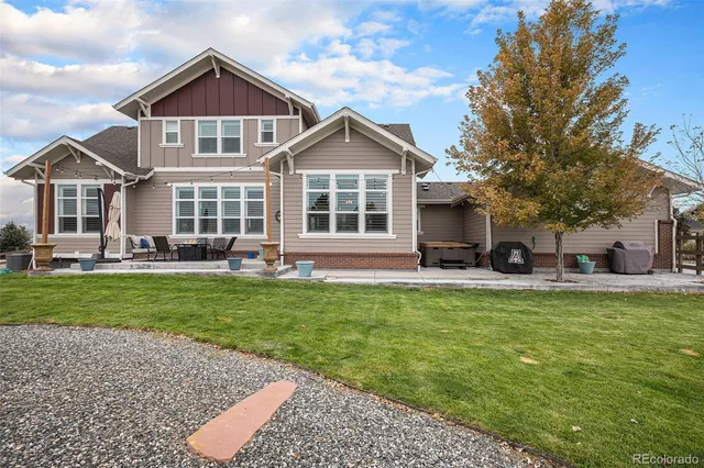a front view of a house with a yard table and chairs