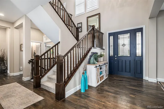 a view of an entryway with hardwood floor and staircase