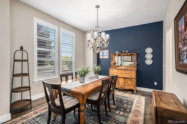 a view of a dining room with furniture and chandelier