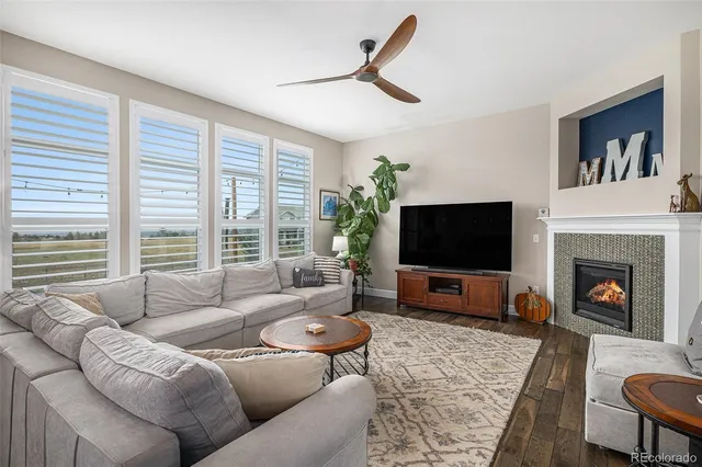 a living room with furniture window and a flat screen tv